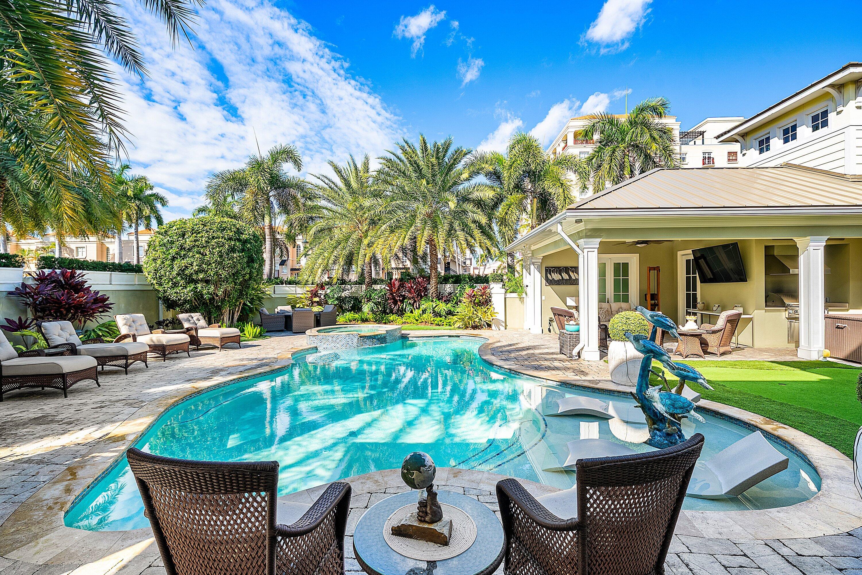 201 Northeast 3rd Court Boca Raton, FL 33432 - Photo 52 of 84 a view of a patio with table and chairs potted plants and palm tree