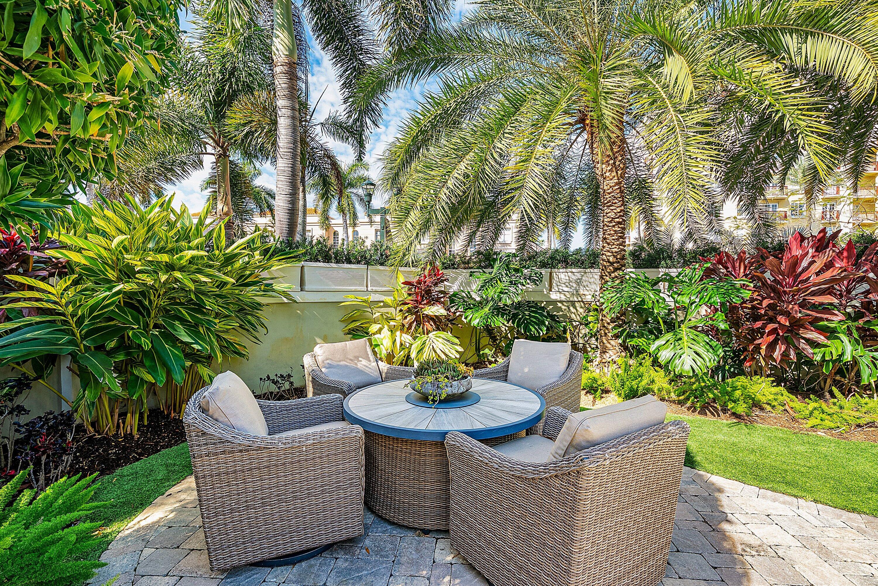 201 Northeast 3rd Court Boca Raton, FL 33432 - Photo 55 of 84 a view of a patio with couches and a table and chairs with garden