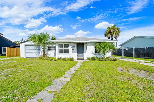 a front view of house with yard and outdoor seating