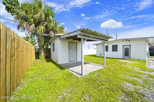 a view of a house with a yard and roof