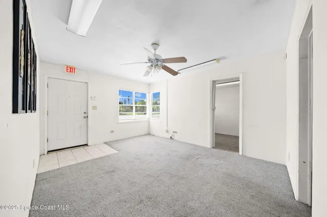 an empty room with closet and windows