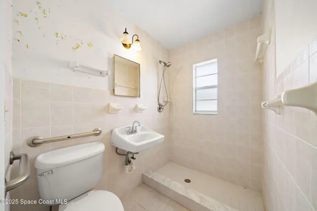 a white toilet sitting next to a bathroom sink