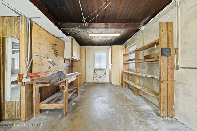 a view of a hallway with wooden cabinets