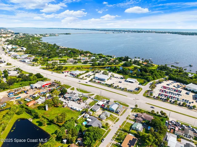 an aerial view of a houses with yard