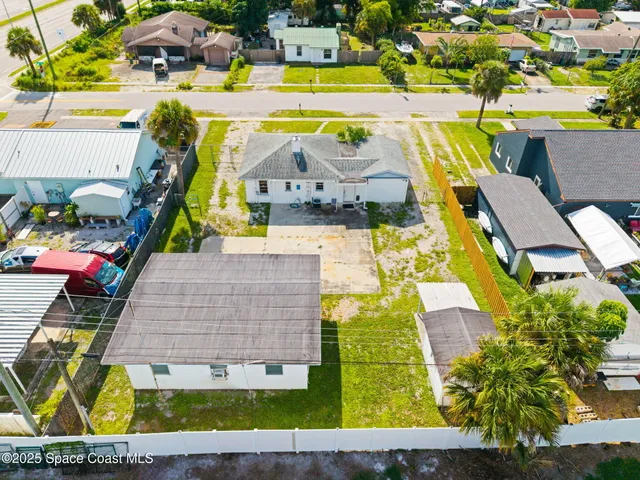 an aerial view of a house with a swimming pool