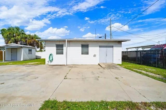 a view of a house with a backyard and a garage