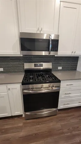 a stove top oven sitting inside of a kitchen