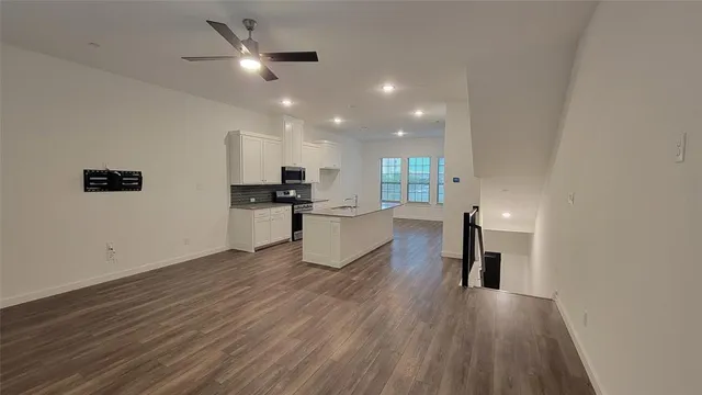 a kitchen with a sink stainless steel appliances and cabinets