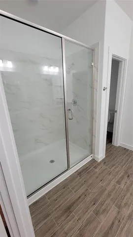 a bathroom with a glass shower door