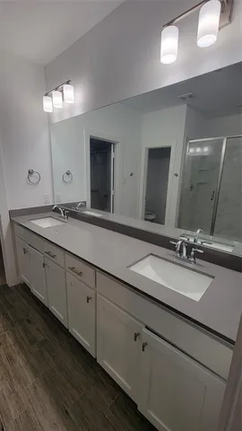 a bathroom with a double vanity sink and mirror