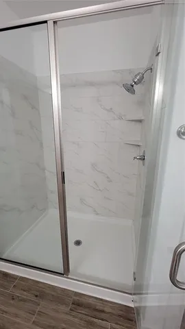 a bathroom with a glass shower door