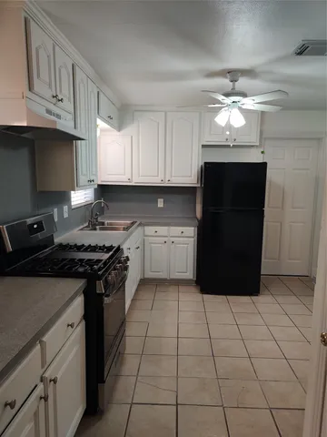 a kitchen with a cabinets and steel stainless steel appliances