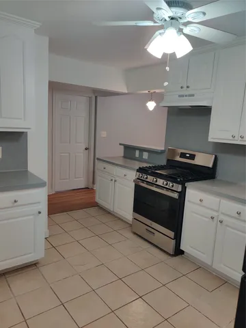 a kitchen with stainless steel appliances a stove a sink and a refrigerator