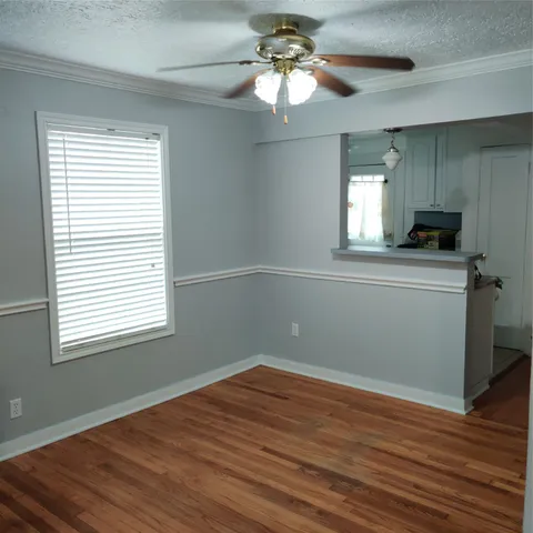 a view of a kitchen with a dishwasher cabinets and a wooden floor