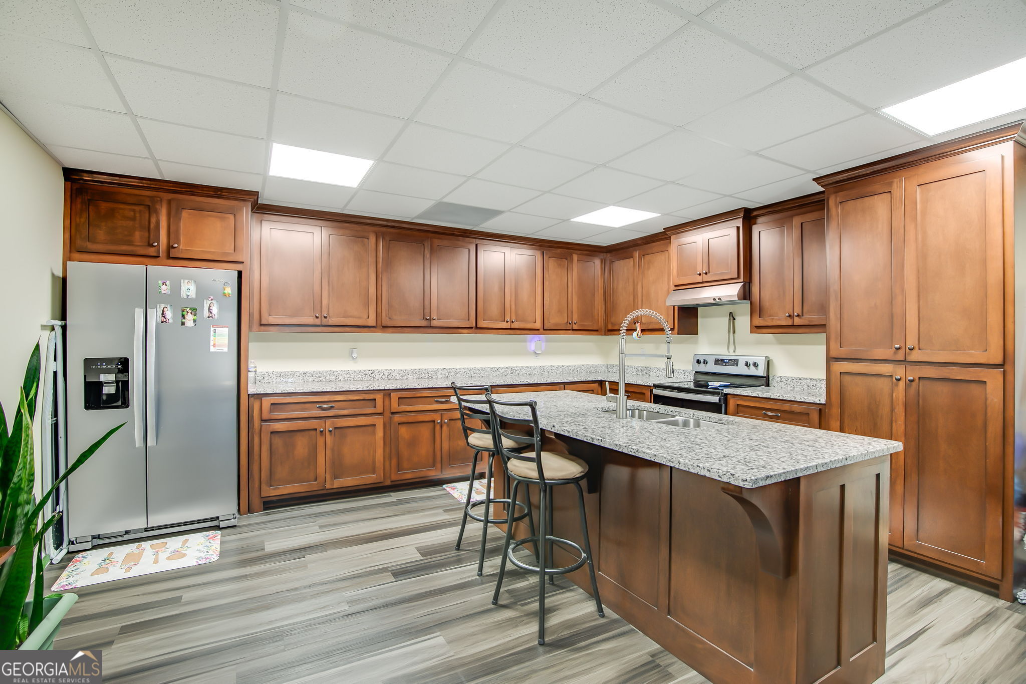 733 Cherry Road Franklin, GA 30217 - Photo 17 of 22 a kitchen with stainless steel appliances granite countertop a refrigerator a sink dishwasher a stove and white countertops with wooden floor