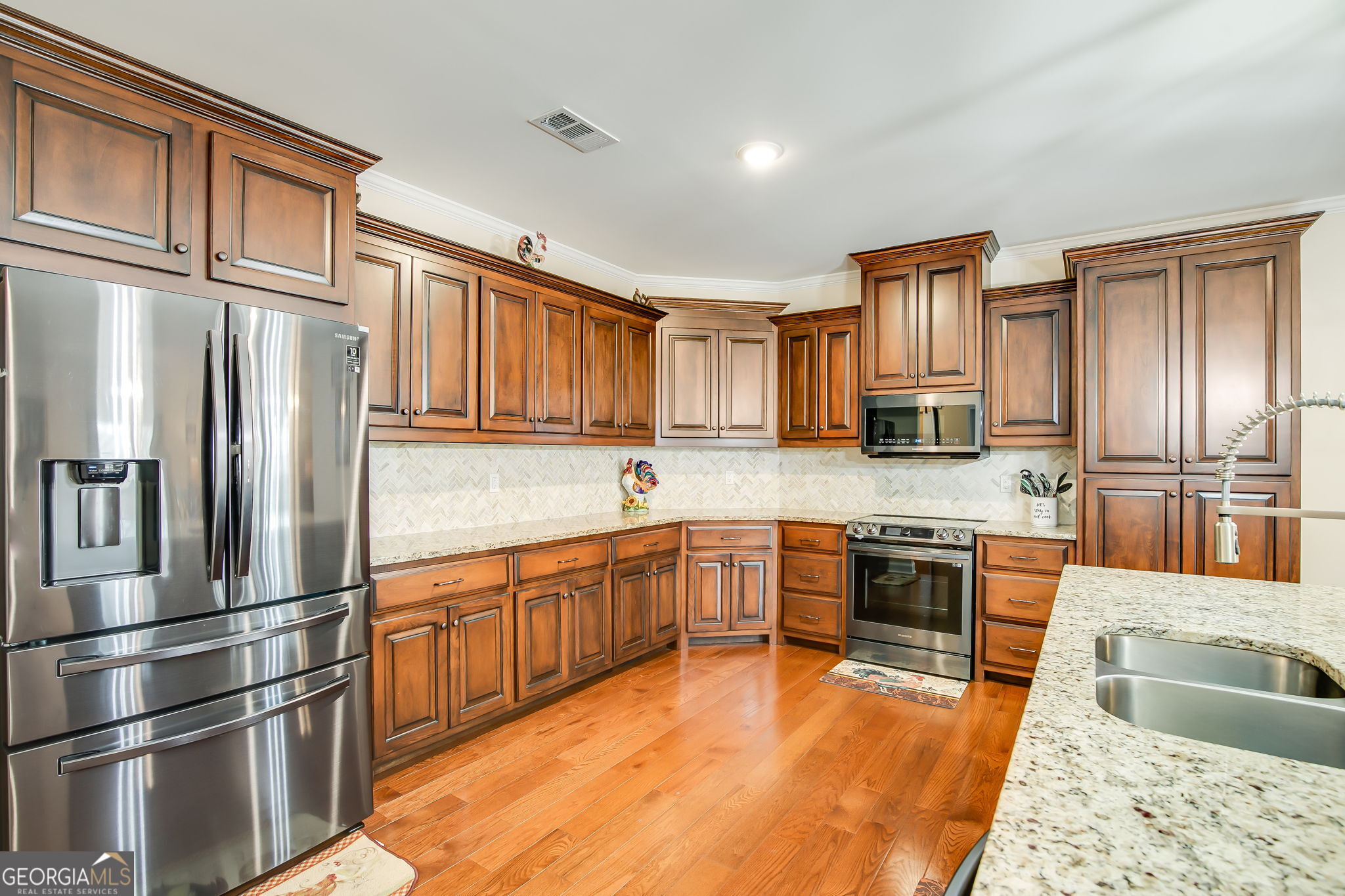 733 Cherry Road Franklin, GA 30217 - Photo 19 of 88 a large kitchen with granite countertop a refrigerator stove top oven and sink