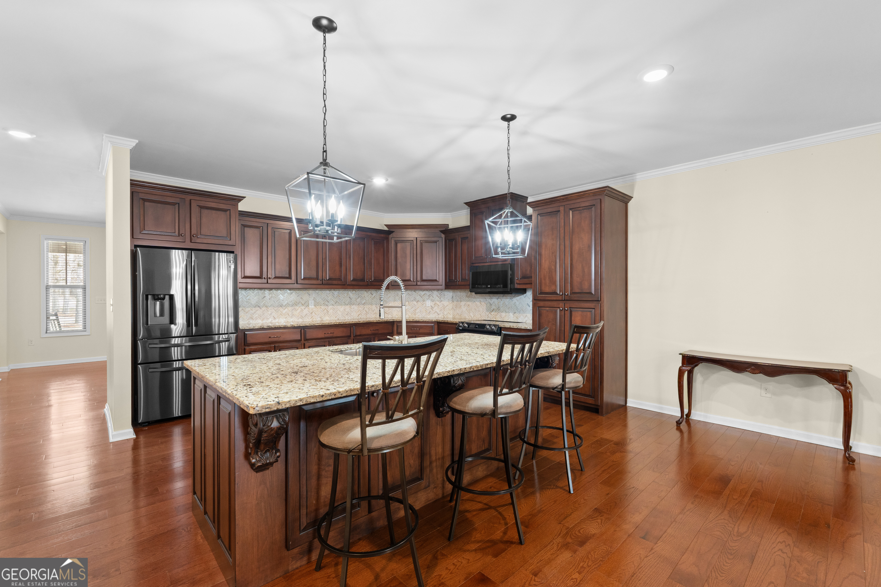 733 Cherry Road Franklin, GA 30217 - Photo 21 of 88 a kitchen with stainless steel appliances a dining table chairs and wooden floor