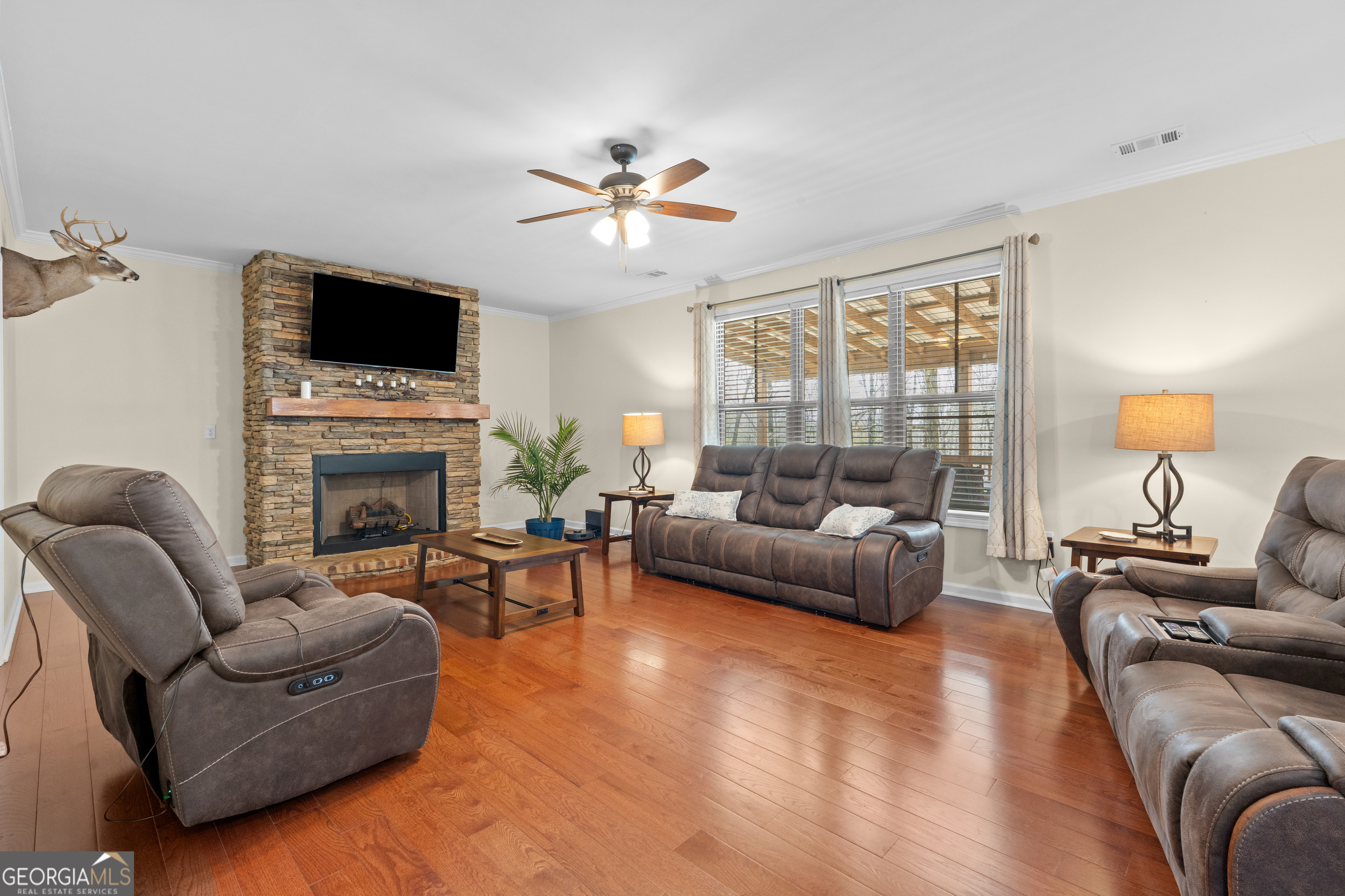 733 Cherry Road Franklin, GA 30217 - Photo 29 of 88 a living room with furniture a fireplace and a flat screen tv