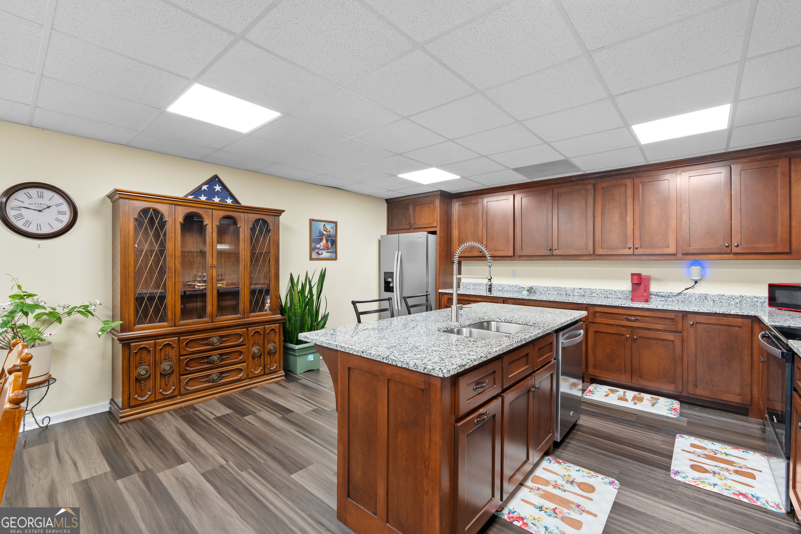 733 Cherry Road Franklin, GA 30217 - Photo 53 of 88 a kitchen with wooden cabinets and center island