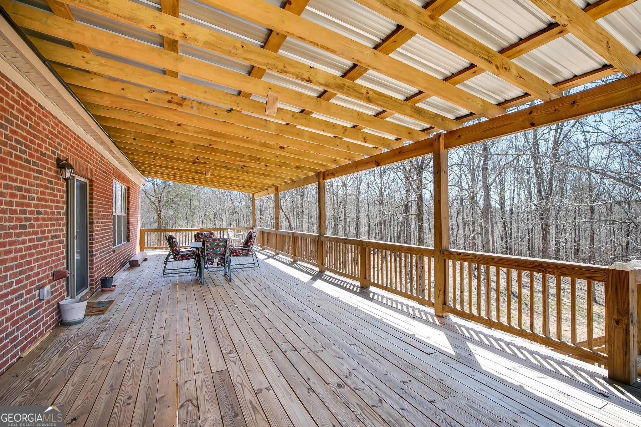 733 Cherry Road Franklin, GA 30217 - Photo 9 of 88 a view of a patio with table and chairs with wooden floor