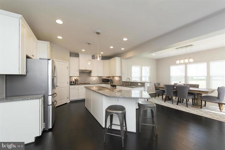 10431 Windlass Run Road Baltimore, MD 21220 - Photo 11 of 30 a kitchen with a table chairs stove and refrigerator