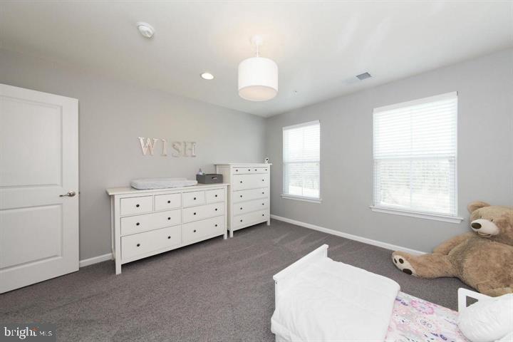 10431 Windlass Run Road Baltimore, MD 21220 - Photo 25 of 30 a spacious bedroom with a bed and a window