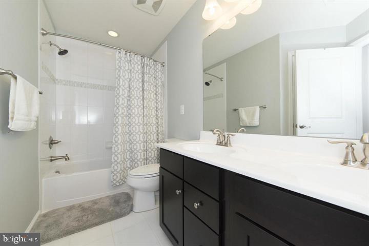 10431 Windlass Run Road Baltimore, MD 21220 - Photo 26 of 30 a bathroom with a sink a toilet and shower