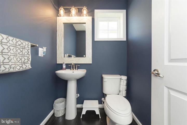 10431 Windlass Run Road Baltimore, MD 21220 - Photo 6 of 30 a bathroom with a toilet a sink and mirror
