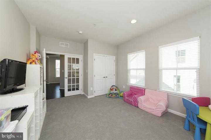 10431 Windlass Run Road Baltimore, MD 21220 - Photo 7 of 30 a spacious bedroom with a bed and flat screen tv