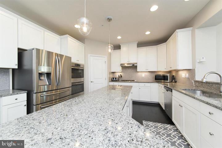 10431 Windlass Run Road Baltimore, MD 21220 - Photo 10 of 30 a kitchen with granite countertop a refrigerator sink and cabinets