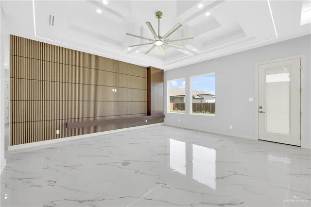 a kitchen with white cabinets and window