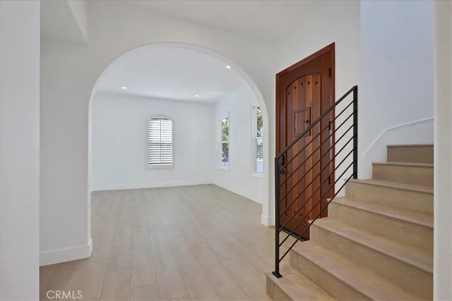 a view of an entryway with wooden floor and stairs