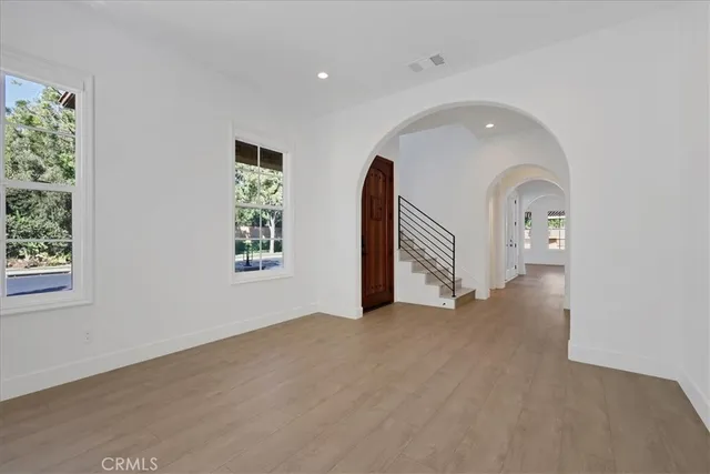 a view of an empty room with wooden floor