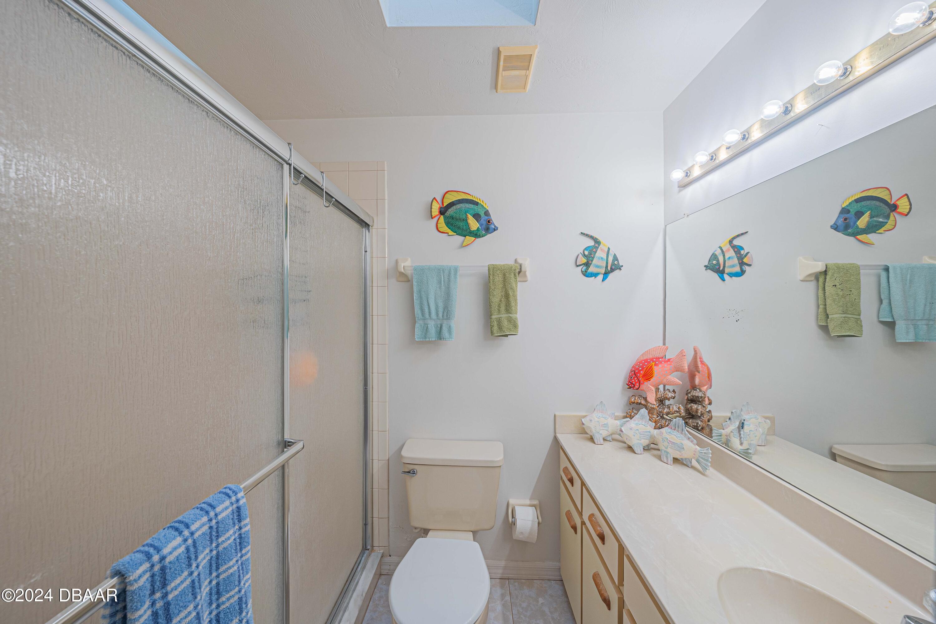 42 Jana Drive Ponce Inlet, FL 32127 - Photo 26 of 34 a bathroom with a sink mirror vanity and toilet