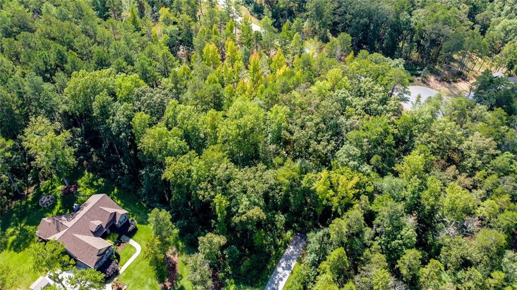 Lot 30 Harbor Point Seneca, SC 29672 - Photo 5 of 12 An aerial perspective reveals a secluded residence nestled amidst a vibrant, mature woodland setting.
