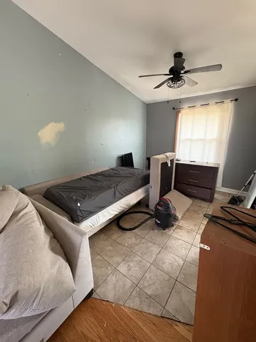 a bedroom with furniture and a window