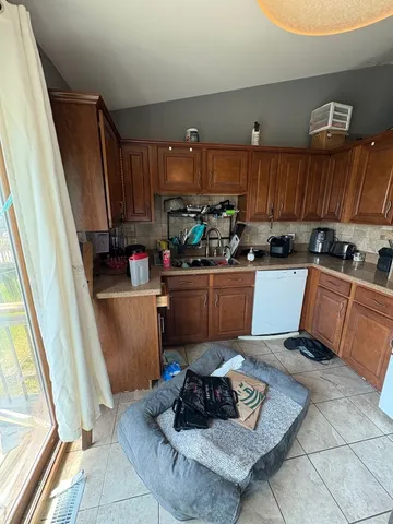 a kitchen with a sink a counter cabinets and appliances