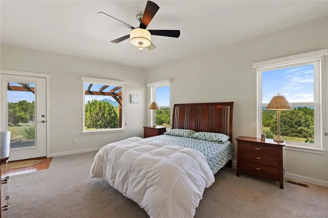 a spacious bedroom with a bed and a window