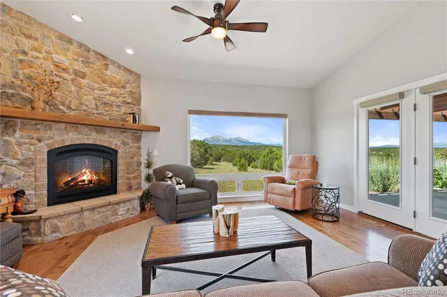 a living room with furniture fireplace and window