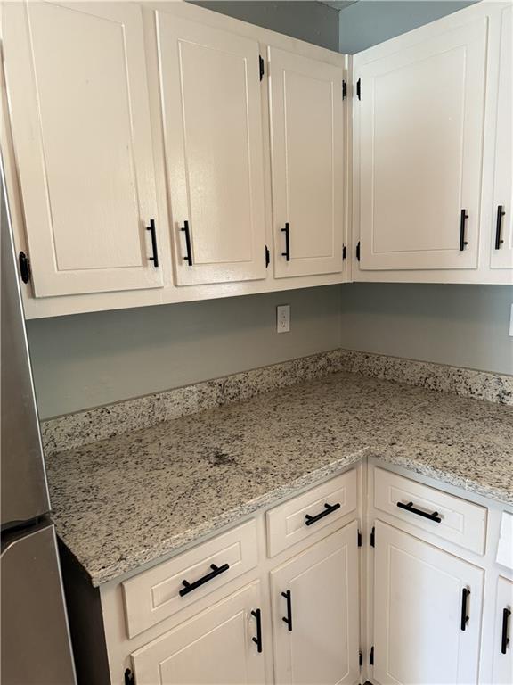 975 Ridgedale Drive Lawrenceville, GA 30043 - Photo 8 of 31 a kitchen with granite countertop white cabinets and a white appliances