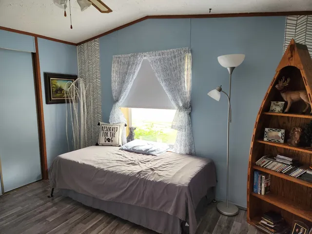 a bedroom with a bed and a potted plant