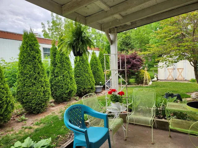 a living room with furniture and flowers