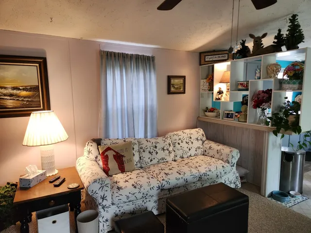 a kitchen with kitchen island a stove and a sink