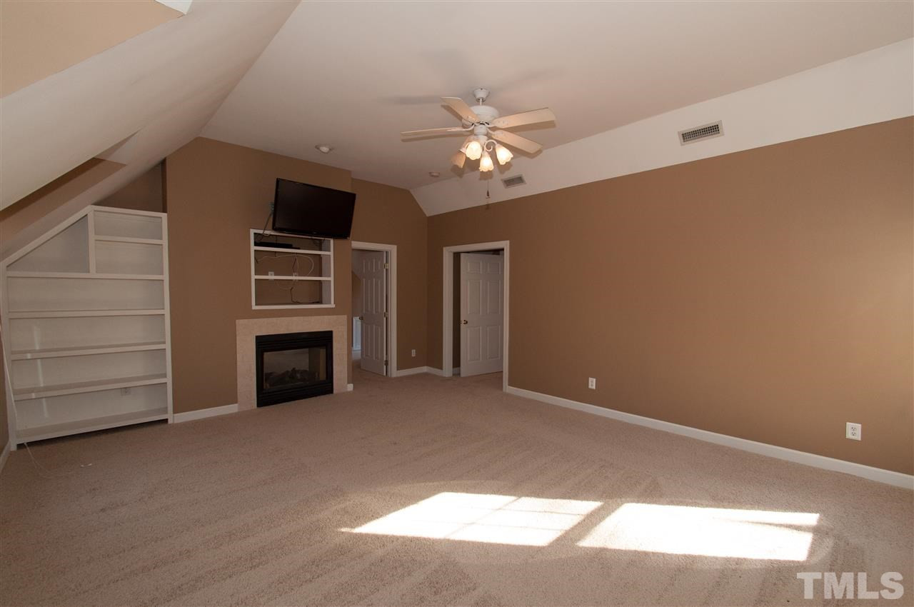 13423 Melvin Arnold Road Raleigh, NC 27613 - Photo 16 of 25 Spacious master suite with see thru gas log fireplace, sitting room, whirlpool bath and walk-in closet Master Bedroom