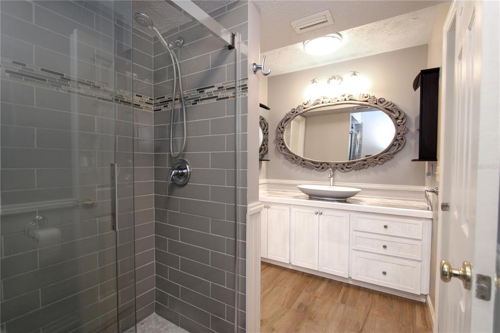 106 Phillips Drive Seffner, FL 33584 - Photo 28 of 48 a bathroom with a granite countertop sink a mirror and shower