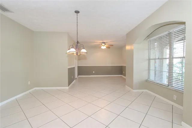 a view of a livingroom with wooden floor and a window