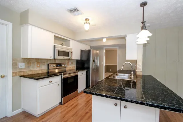 a bedroom with a large bed couch and a window