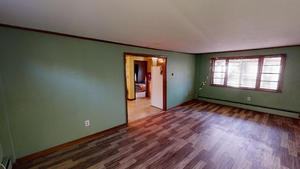 11 River Road Templeton, MA 01436 - Photo 6 of 32 an empty room with wooden floor and windows