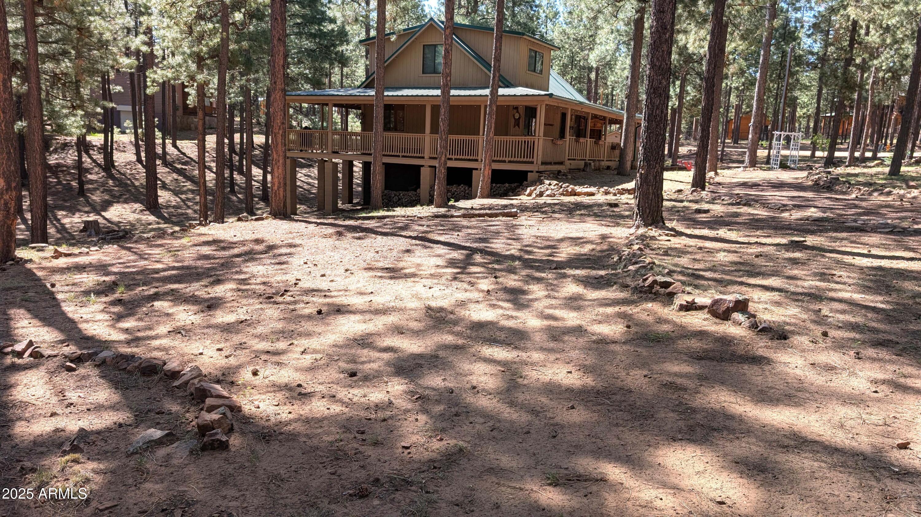 2425 Tall Trees Loop Forest Lakes, AZ 85931 - Photo 37 of 43 a front view of a house with a yard covered with snow