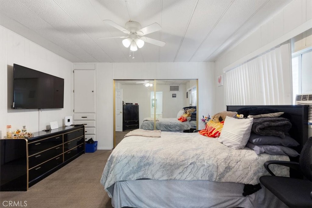 300 North Rampart Street, Unit 195 Orange, CA 92868 - Photo 14 of 25 a bedroom with a bed and a flat tv screen on dresser